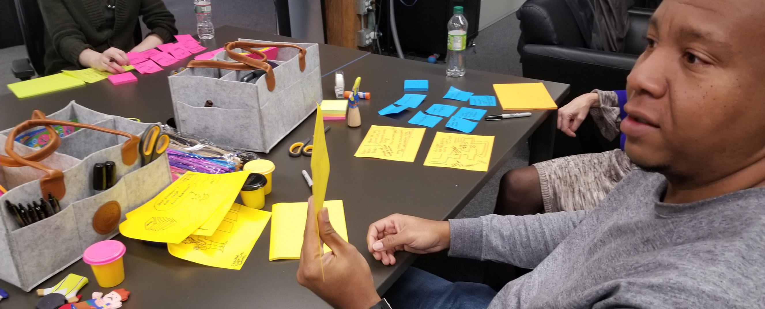 A person holding up a post-it note