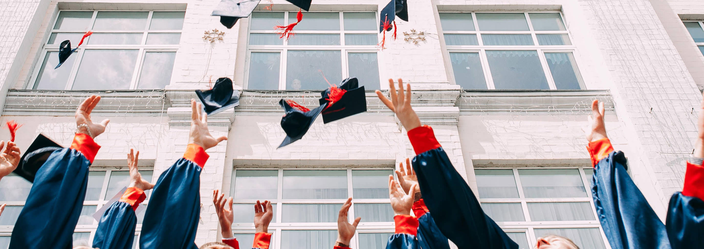 Graduation hats thrown into the air